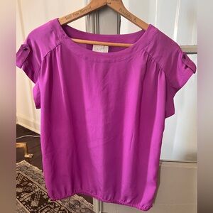 Work/dressy blouse with elastic gathering at waist.